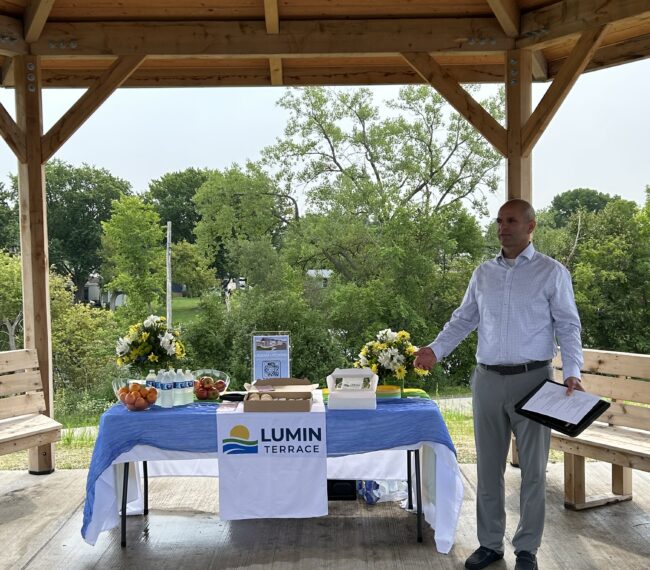 Scott Kwiecincki, President of Horizon Development Group, speaks at the Lumin Terrace grand opening event at the community gazebo in Watertown, Wisconsin